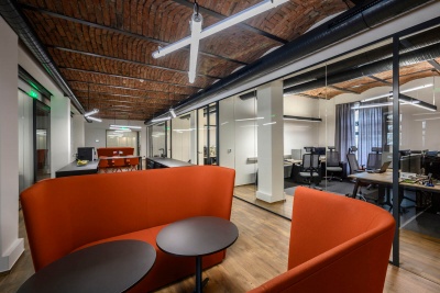 Modern glass partition with a historic vaulted ceiling